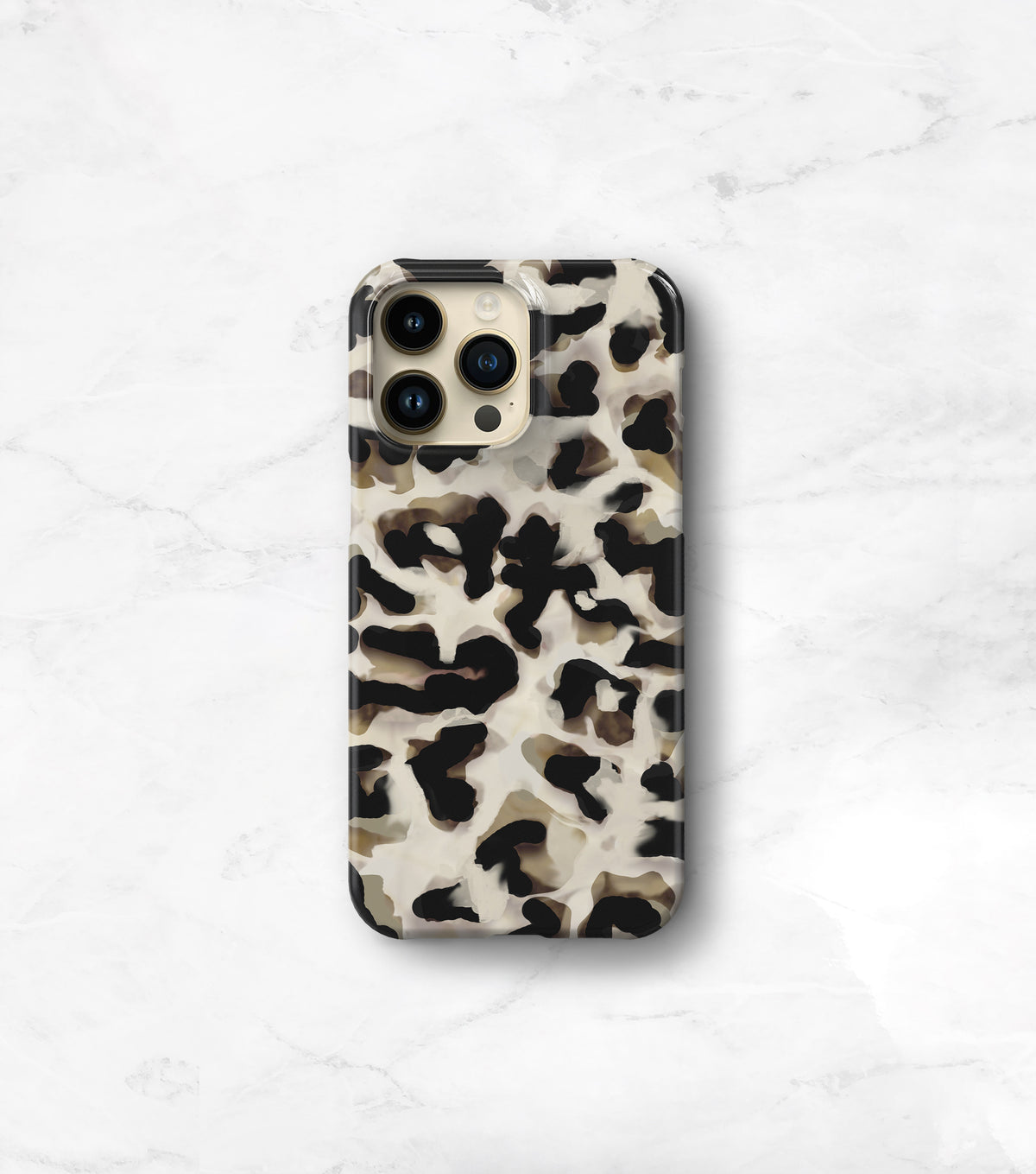 A leopard print phone case is displayed on a marble surface.