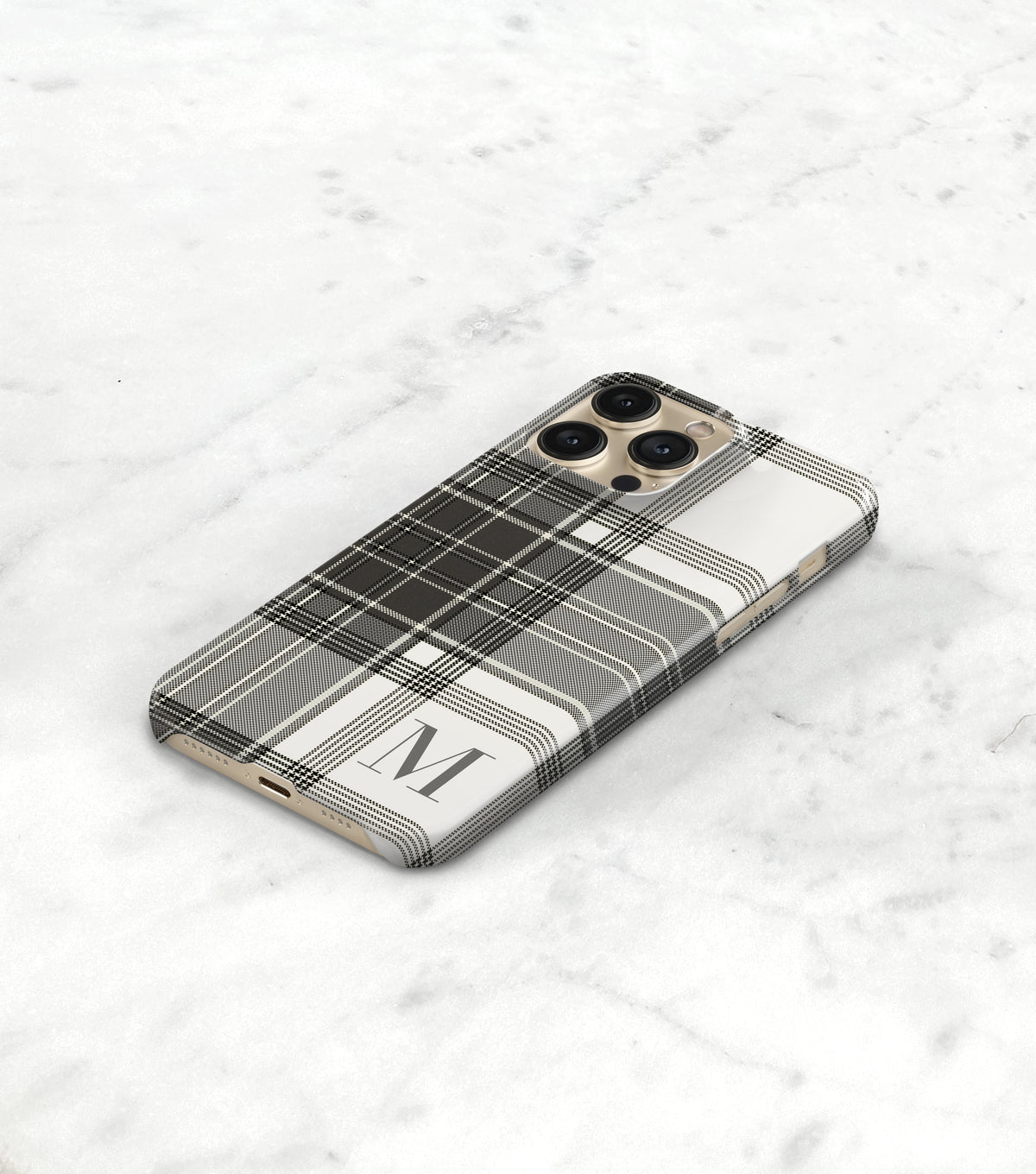 a smartphone with a black and white plaid pattern on its case, resting on a white marble surface.