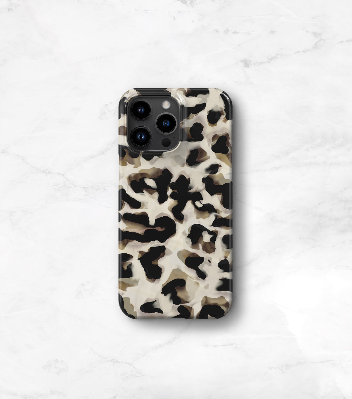 A leopard print phone case is displayed on a marble surface.