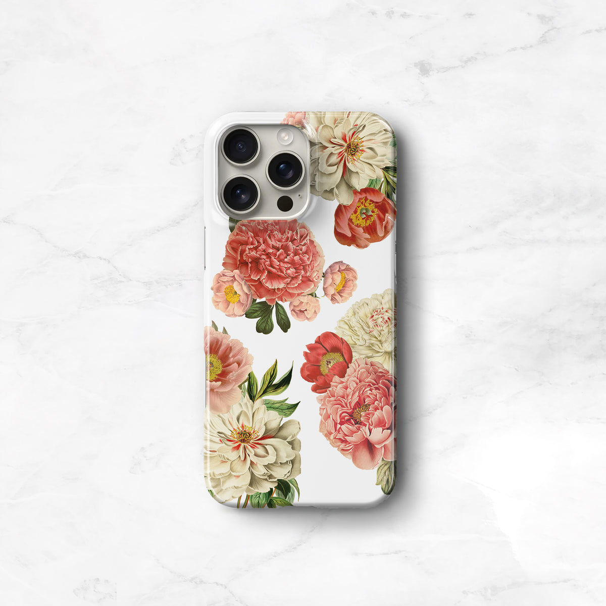 a white phone case with a floral design on it, placed on a marble surface.