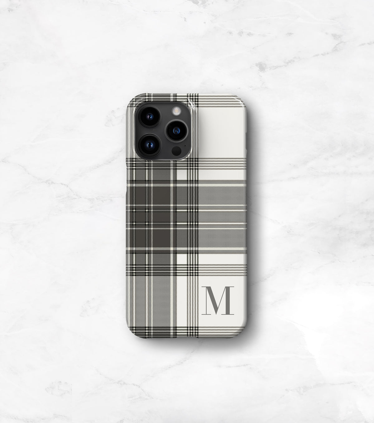 a phone case with a plaid pattern and a monogrammed letter &quot;M&quot; on it.