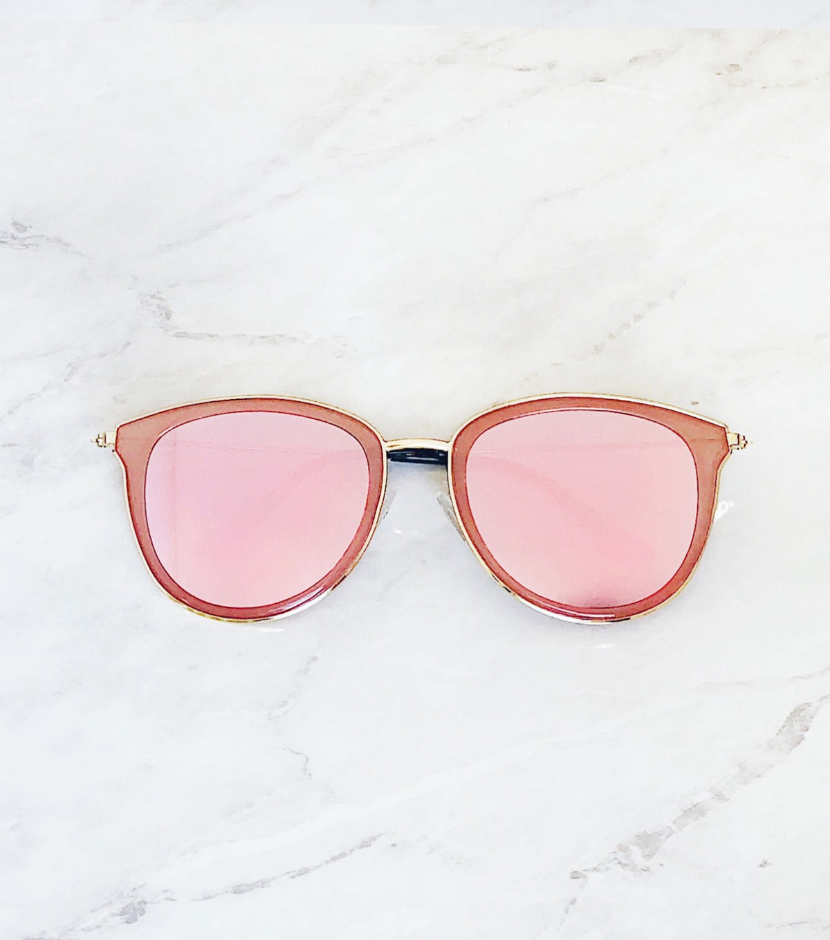 Pink mirrored lenses on pink and gold sunglasses