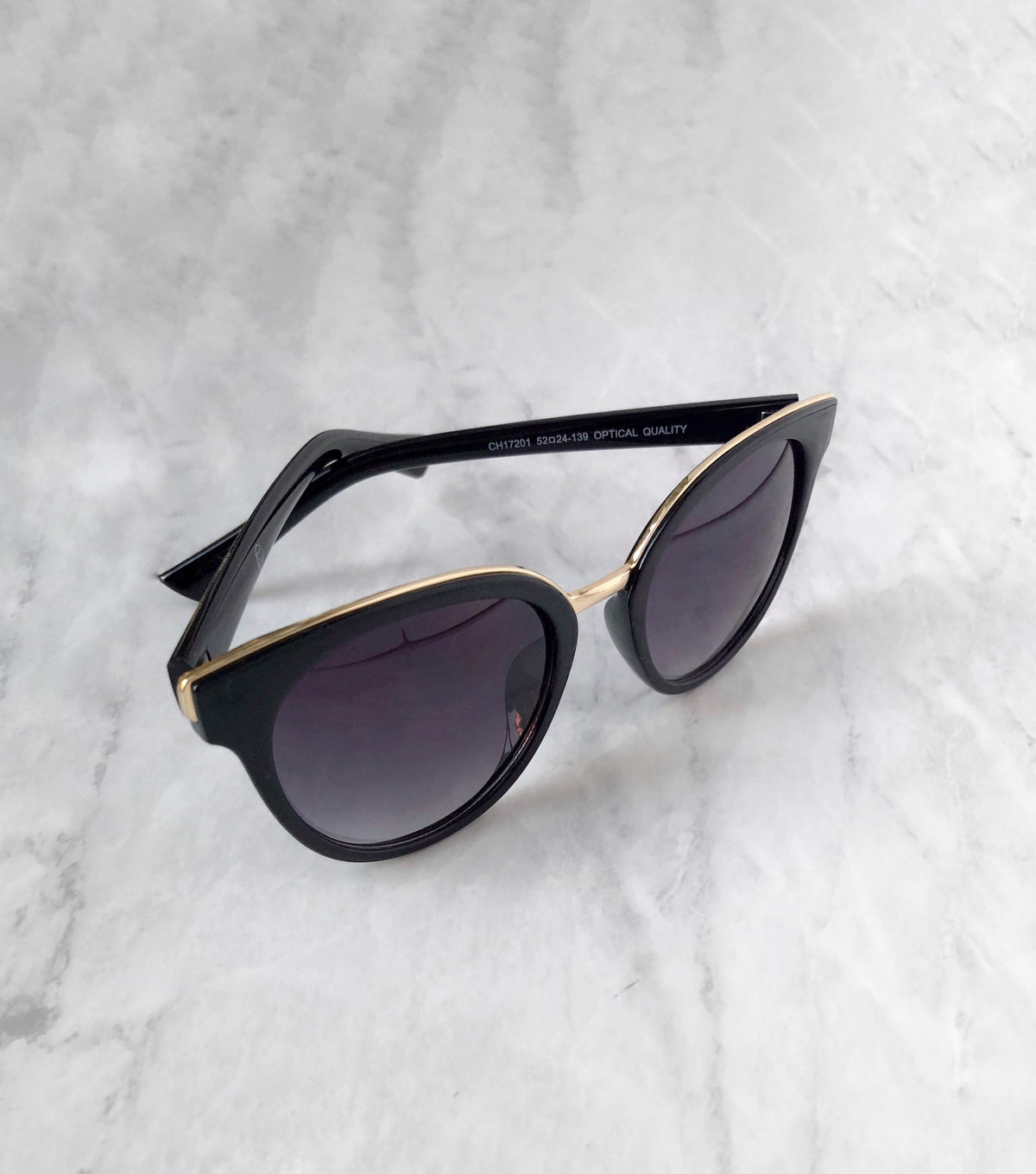 gold brow and bridge on black sunglasses