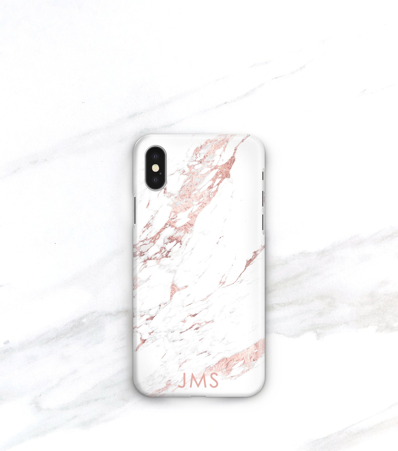 A white marble-patterned iPhone case with a personalized text logo on it, placed on a marble surface.