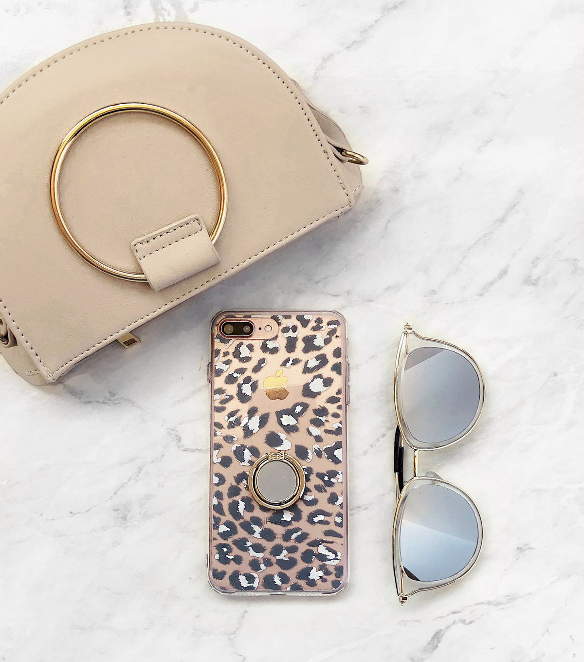 neutral ring bag with leopard print iPhone case and sunnies